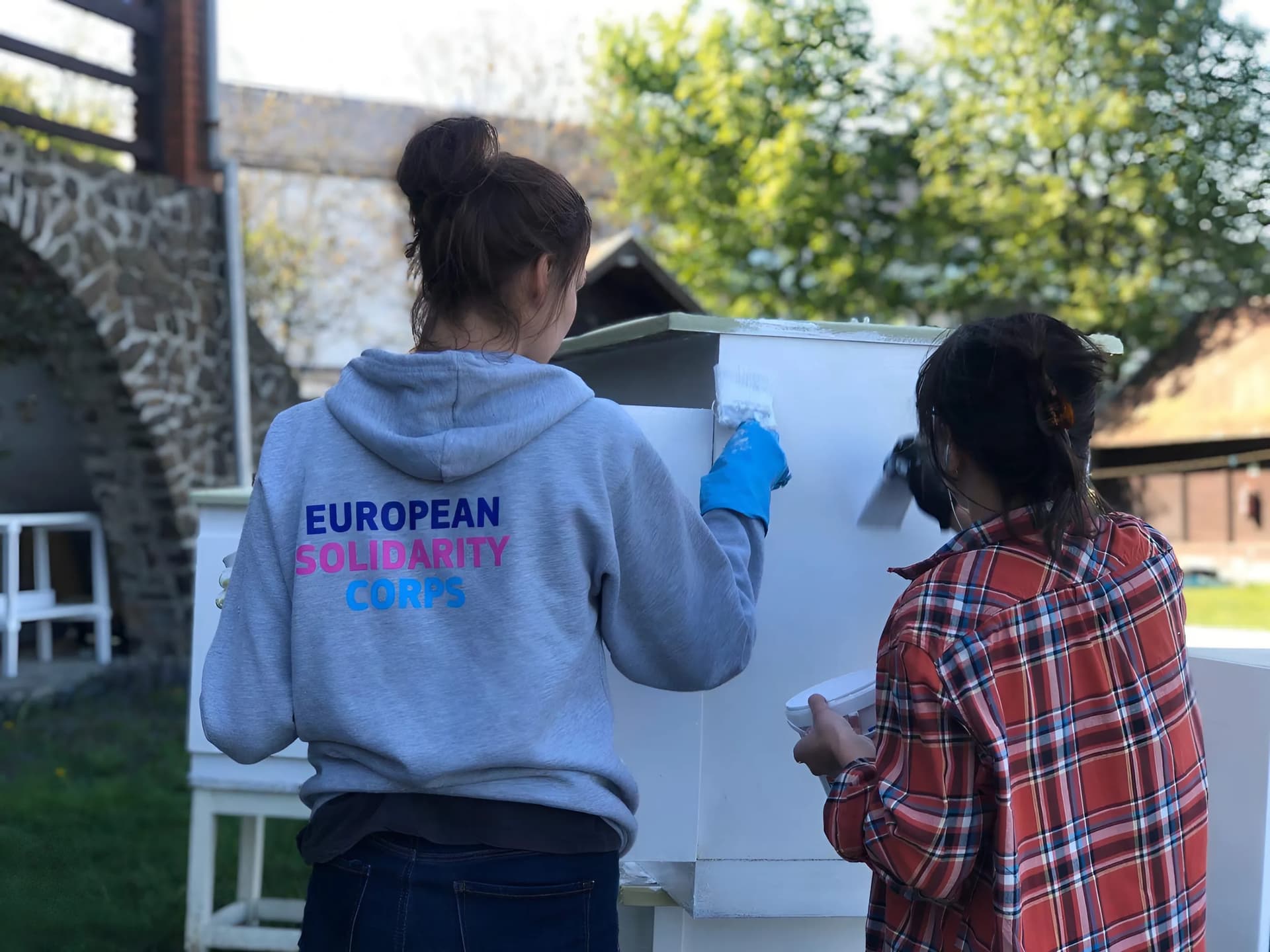 Two youngster painting togather